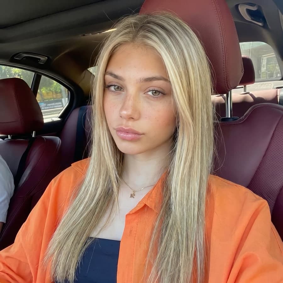 L’égérie blonde Selfika assise dans une voiture